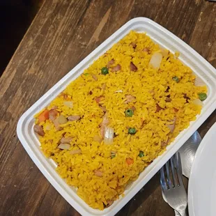 a plate of rice and a fork on a table