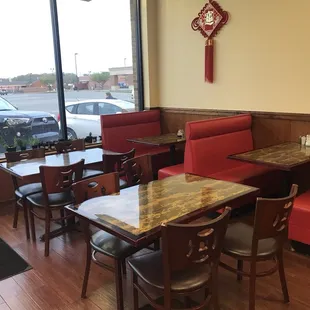 a view of a restaurant with red booths and tables