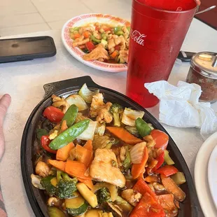 Both side by side. The only difference is the way the veggies are cut and the cashews on top