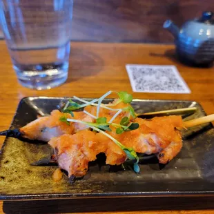 Spicy daikon topped chicken skewer.