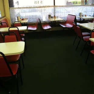 an empty restaurant with red chairs