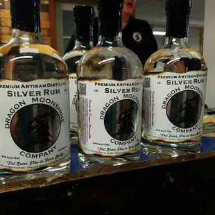 three bottles of silver rum