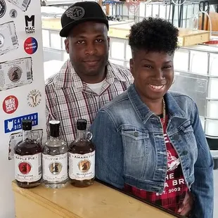 a man and a woman standing behind a counter