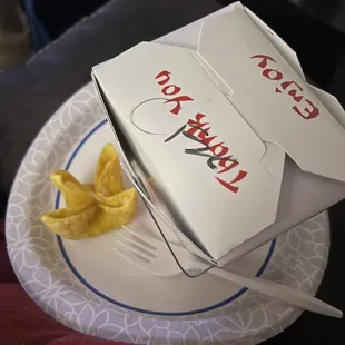 a plate of noodles and a box of pizza