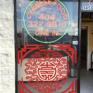 a chinese restaurant with a neon sign