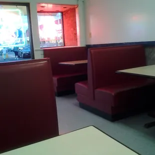 a view of a restaurant with booths and tables