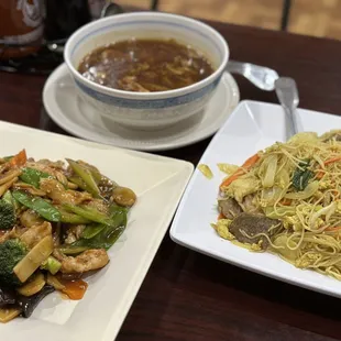 a plate of noodles and a bowl of soup