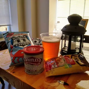 a beer and chips on a table
