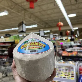 a hand holding a piece of cheese