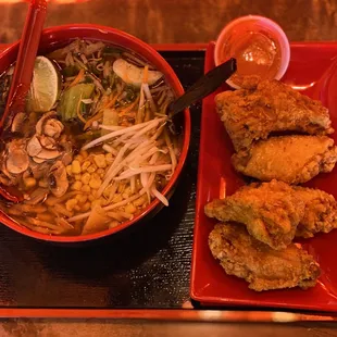 a bowl of noodles and fried chicken