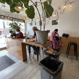 two people sitting at a table in a coffee shop