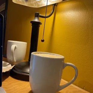 a cup of coffee next to a laptop