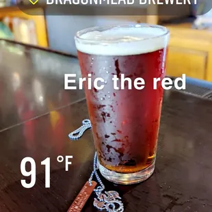 a glass of beer on a bar