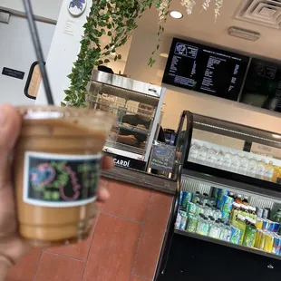 a hand holding a cup of coffee