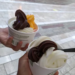 a hand holding a cup of ice cream