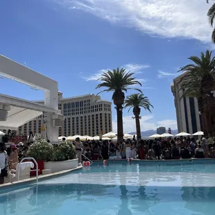 a crowd of people sitting around a pool
