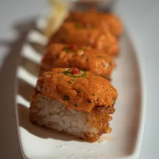 three pieces of sushi on a white plate