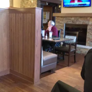 Dining room, television, and fireplace.