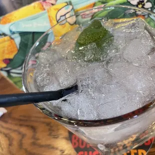 a close up of a drink with ice and mint