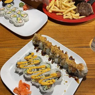 a plate of sushi and french fries
