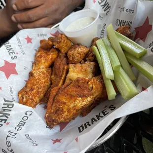 a basket of wings and celery