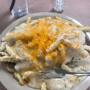 This is a hamburger Patti on bread with French fries and gravy. It is truly comfort food and tastes wonderful