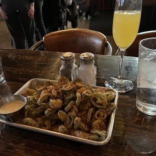 a platter of fried okonos and a glass of water