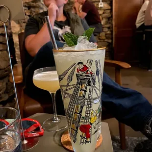 a man sitting at a table with a drink in front of him