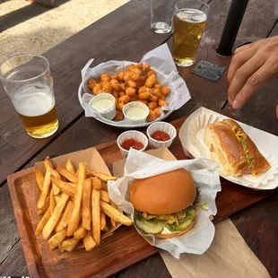 Chicken sandwich, fries, cheese curds, bratwurst.