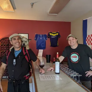 two men standing at a bar