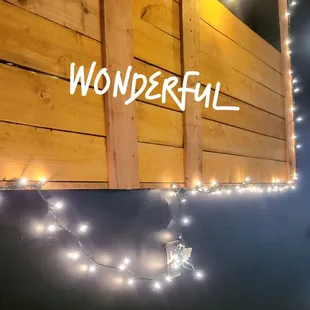 a wooden wall with string lights