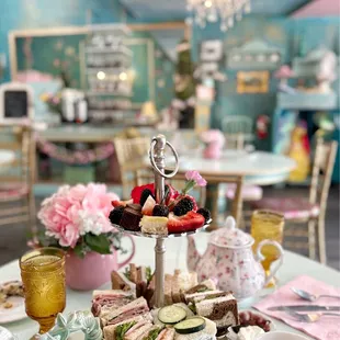 a table with tea and sandwiches