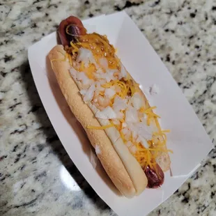 a hot dog with cheese and onions