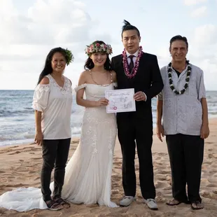 Reverend Walters, Jade and us at our wedding at a north beach of the island during sunset hour.
