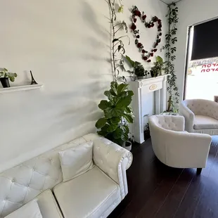 a living room with white furniture