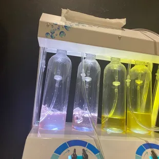 a water purifier with three bottles of liquid