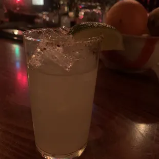 a margarita in a glass with a lime wedge