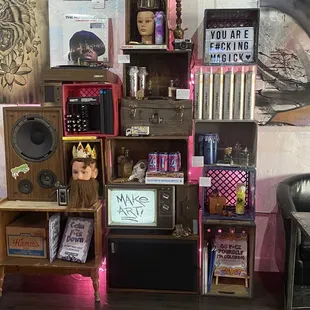 a young boy sitting in a chair in front of a bookshelf