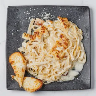 Roasted Halal Chicken Fettuccine Alfredo paired perfectly with Garlic Bread.
