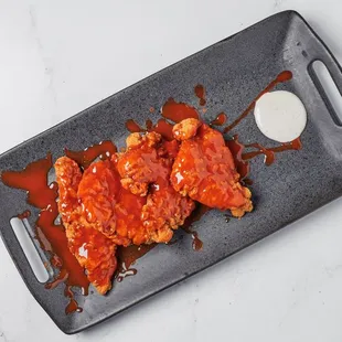 Halal Tenders dipped in Habanero, or BBQ or Franks Hot sauce