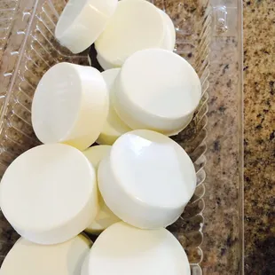 a plastic container filled with white candies