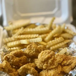 a tray of fried chicken and french fries