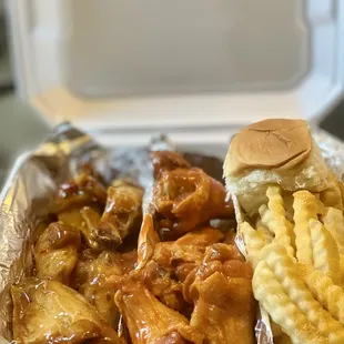 a tray of chicken wings and french fries