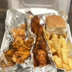 a tray of chicken wings and french fries