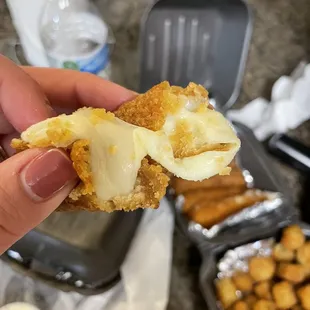 a person holding a piece of food