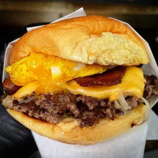 a cheeseburger with bacon and eggs