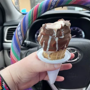 Medium chocolate dipped waffle cone with chocolate peanut butter swirl ice cream.