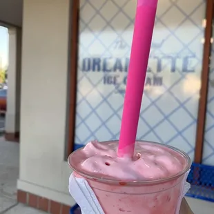 Vanilla shake mixed with cherry and coconut flakes.