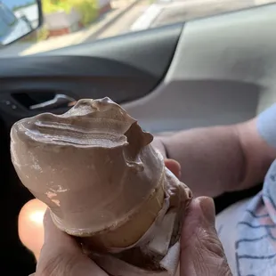 Regular-sized soft serve chocolate ice cream cone.