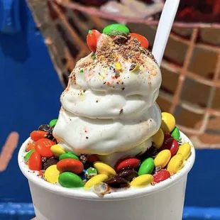 a cup of ice cream with candy